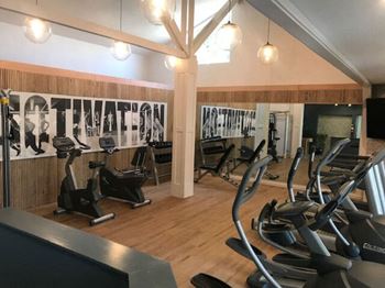 a gym with cardio machines and weights on the floor at Napa Green Apartments LLC, Napa